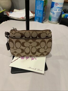 Coach Signature Small Wristlet in a khaki zipped coin purse